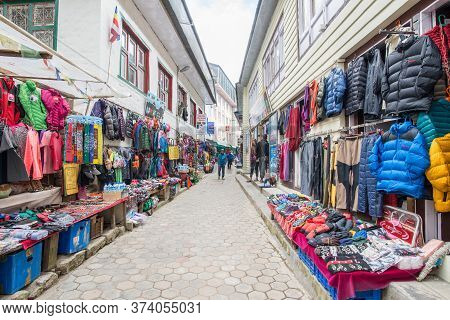 Namche Bazaar, Nepal : October-14-2018 :  The Clothing And Souvenir Shops In The Main Street Of Namc