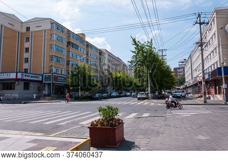 China, Heihe, July 2019: Road With Public Transport. Street Of The Chinese City Of Heihe In Summer