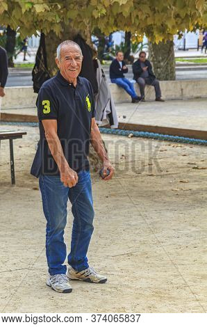 Cannes, France - October 17, 2013: Senior Man Plays Petanque With A Metal Ball In A Park