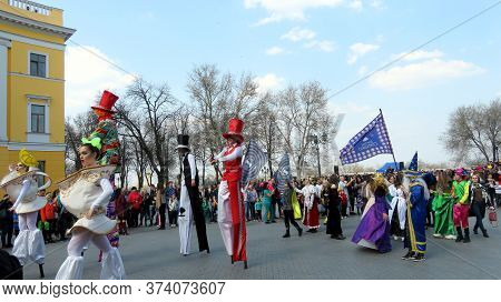 Odessa, Ukraine - 04 01 2019: Princesses And Bright Clowns On Stilts In Front Of A Crowd Of People O