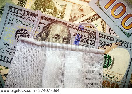 A Hundred-dollar Bill With A Medical Mask .the Concept Of Coronavrius Epidemic