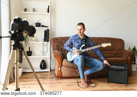 Young Man Records Tutorial Video How To Play Electric Guitar, The Camera On A Tripod Indoors, Combo 