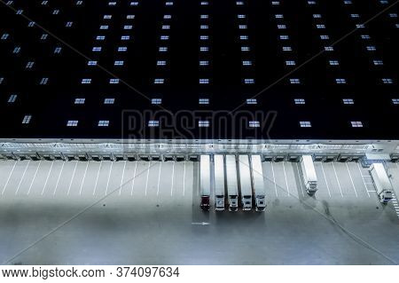 Night Loading Dock At A Warehouse. Modern Logistics Center. Docking Stations Of A Distribution Cente