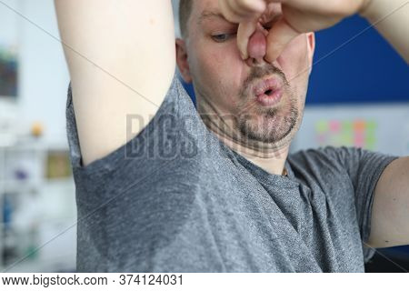 Close-up Of Man After Physical Exertion. Male Person In Tee-shirt With Sweaty Underarm. Sweat On Gre