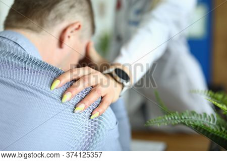 Close-up Of Doctor Trying To Reassure Patient. Practitioner Reporting Bad News To Sick Male Person. 