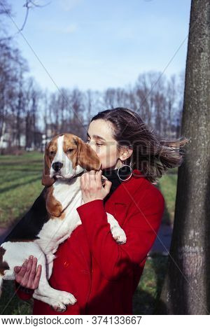 Pretty Young Girl In Redd Coat Playing With Dog Outside In Green Park, Lifestyle People Concept