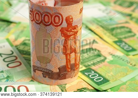 Russian Banknote 5000 Rubles Is On The Field Of Banknotes 200 Rubles. Close-up
