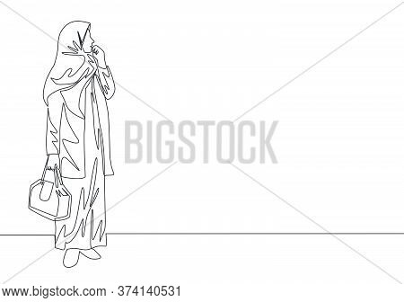 One Continuous Line Drawing Of Young Happy Attractive Muslimah With Veil Holding Pocket Bag. Beautif