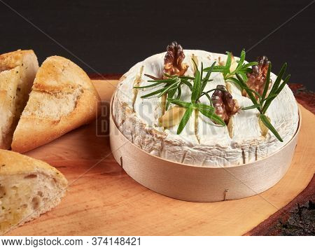 Baked Camembert With Walnuts, Rosemary Stalks And Garlic Cloves, Served With Crusty Garlic Gread, On