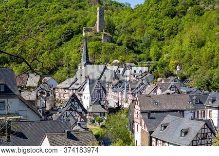 Scenic View On Half-timbered Houses And Ruin Loewenburg In The Village Monreal, Eifel, Germany