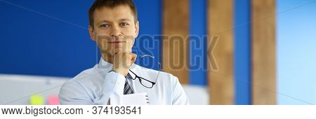Portrait Of Businessman Posing On Camera Holding Clipboard. Smart Attractive Guy In Presentable Suit