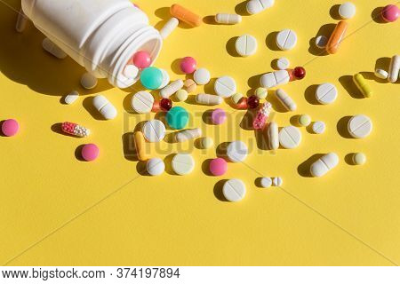 Prescription Drugs And Pill Bottle.colorful Pills Pouring Out Of The White Bottle. Antibiotic Capsul