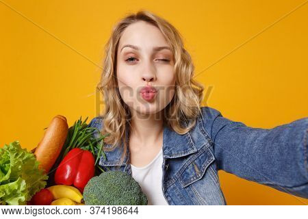 Close Up Of Young Woman In Denim Clothes Isolated On Orange Background. Delivery Service From Shop O