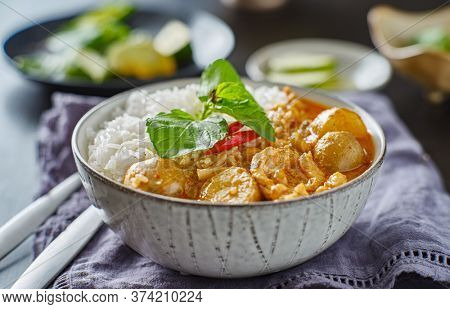 thai massaman chicken curry in bowl with jasmine rice