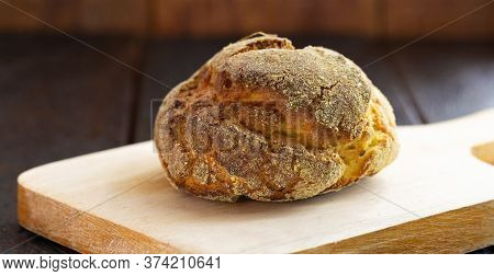 Small Homemade Bread, Biscuit Called Broa Or Broinha, Bread Made From Corn, On A Rustic Wooden Backg