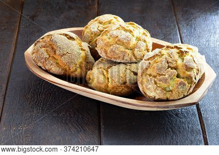 Small Homemade Bread, Biscuit Called Broa Or Broinha, Bread Made From Corn, On A Rustic Wooden Backg