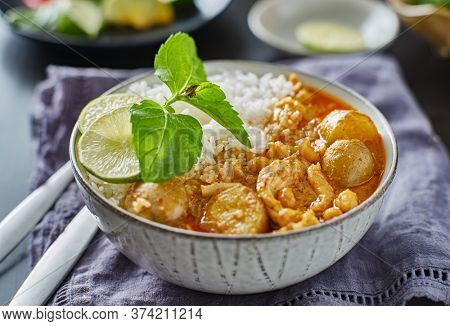 thai massaman chicken curry in bowl with jasmine rice