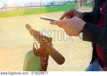 Close Up Image Of A Man On An Electric Scooter Paying Online. Smart City