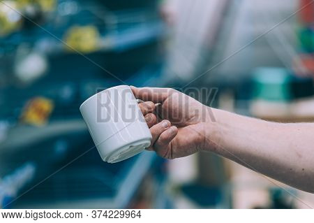 Mockup Mug In A Man Hand, Against The Background Of Shop Windows.