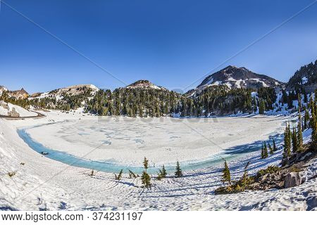 Snow On Mount Lassen In The Lassen Volcanic National Park With Glacier Lake, Usa