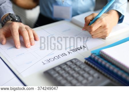 Close-up Of Couple Accounting Family Budget. Paper For Planning Wastes On Every Month. Man And Woman