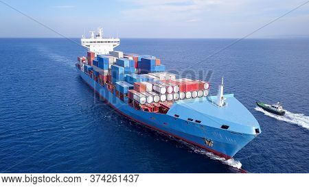 Ulcv Container Ship Sails On Open Water Fully Loaded With Containers And Cargo.