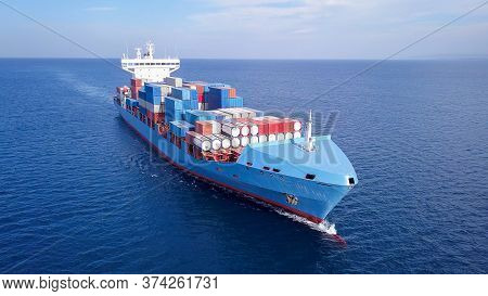 Ulcv Container Ship Sails On Open Water Fully Loaded With Containers And Cargo.