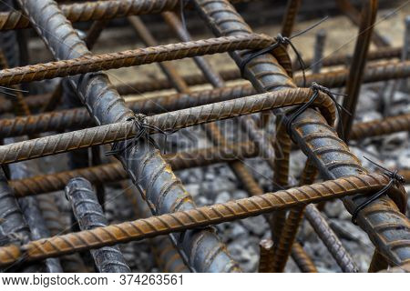 Rebar Tie Wire Work At Construction Site. Steel Bars Reinforcing For Reinforced Concrete And Buildin