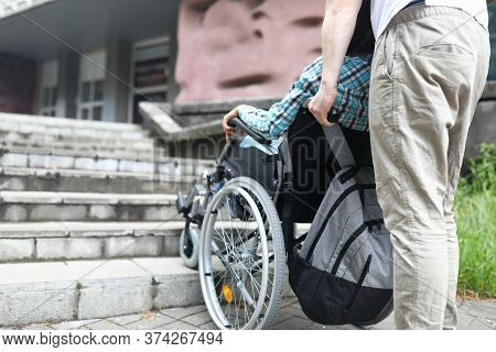 Close-up Of Male Helping Woman To Get Upstairs Outdoors. Man Taking Care Of Female Friend. Walking I