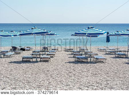 Umbrellas And Sunbeds On Traganou Beach, Rhodes Island, Greece