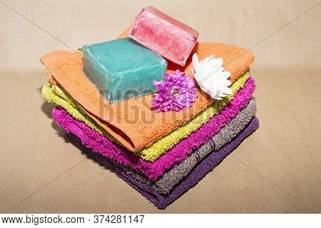Soap Bar On Top Of Facecloths Off Various Shades With Flowers