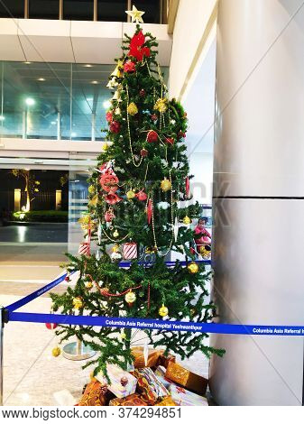 Beautiful View Of Christmas Tree Decoration With Bell, Gift Box And Star. Done At Entrance Of Columb