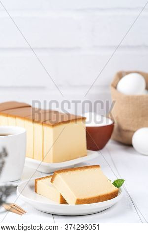 Castella (kasutera) - Beautiful Delicious Japanese Sliced Sponge Cake Food On White Plate Over Rusti