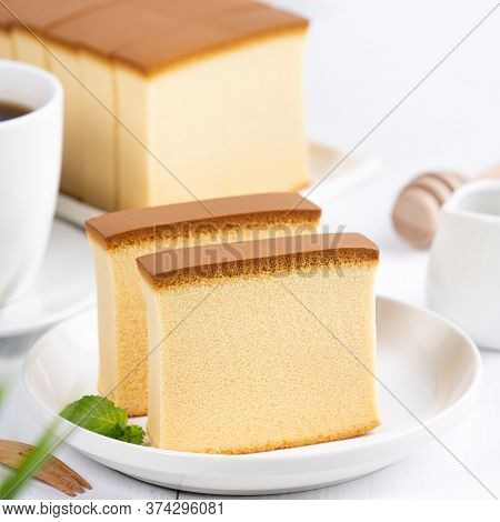 Castella (kasutera) - Beautiful Delicious Japanese Sliced Sponge Cake Food On White Plate Over Rusti