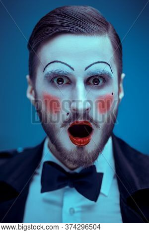 Art and fashion. Portrait of a young man with makeup in the style of the 20s in an elegant suit playing different life roles. Male mime artist.