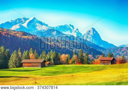 Splendid View Of Alpine Meadow Near Wagenbruchsee (geroldsee) Lake With Wooden Huts And Zugspitze Mo