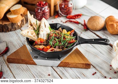 Mexican Dish Fajitos With Beef Vegetables And Pita In A Pan, Horizontal