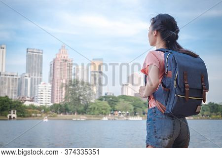 Asian Woman Tourist Traveller Backpack Watching The Beauty Of The Cityscape. At The Scenic Spot With