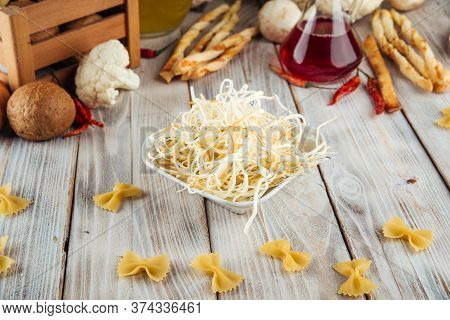 Fiber Smoked Cheese Chechil In A Bowl On The White Wooden Table, Horizontal