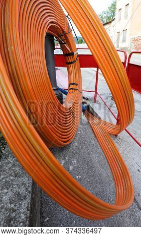 Long Fiber Optic Piping On A Construction Site In The Middle Of The Road To Connect Families And Bus
