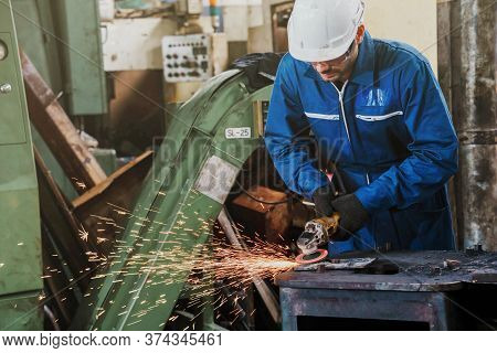 Technician Worker Work  With Electric Metal Grinding Disc On Steel Structure In A Factory.  Industri