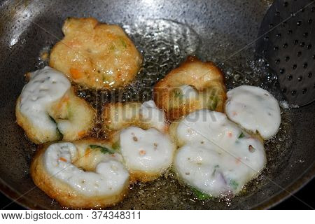 South Indian Cuisine - Vada Or Medu Vadai Frying In Coconut Oil. Very Popular South Indian Snack.
