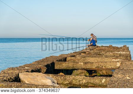 Poti, Georgia - 23, June 2020: Fisherman Fishes On The Black Sea, Poti