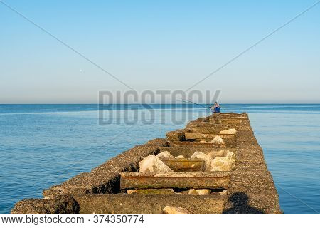 Poti, Georgia - 23, June 2020: Fisherman Fishes On The Black Sea, Poti