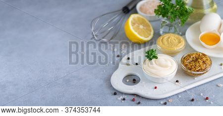 Cooked Homemade Mayonnaise In Bowl With Ingredients For Cooking: Eggs, Olive Oil, Mustard, Lemon On 