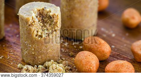 Sweet Pieces Peanut Butter On A Rustic Table, Called Brazilian Paçoca.