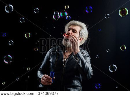 Man Blowing Bubbles. Soap Bubbles. Play With Bubbles. Bearded Man Blowing Soap Bubbles. Happiness. C