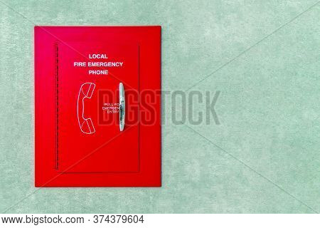 Red Box Of Fire Emergency Phone. Red Box Emergency Phone On The Wall. Telephone Fire Alarm.