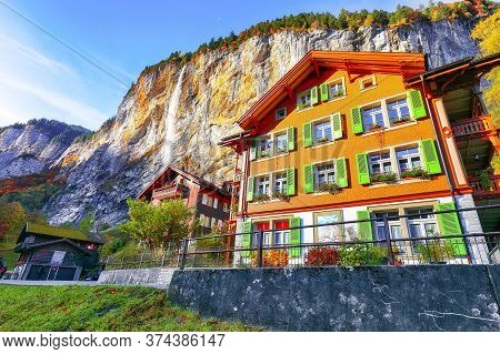 Fantastic Autumn View Of Lauterbrunnen Village With Awesome Waterfall  Staubbach  In The Background.