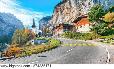 Gorgeous Autumn Landscape Of  Alpine Village Lauterbrunnen With Famous Church And Staubbach Waterfal